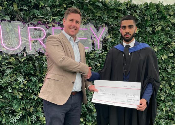 Najam Saqib is pictured shaking hands with Robbie Brown who won the CASE prize at Najam's graduation.